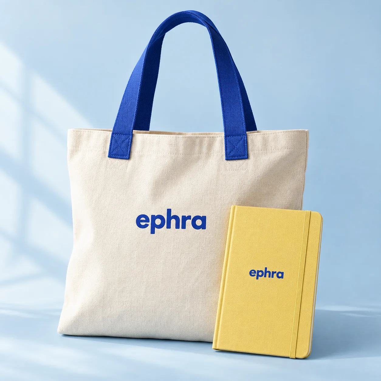 Ephra tote and yellow notebook arranged together. Product concept.