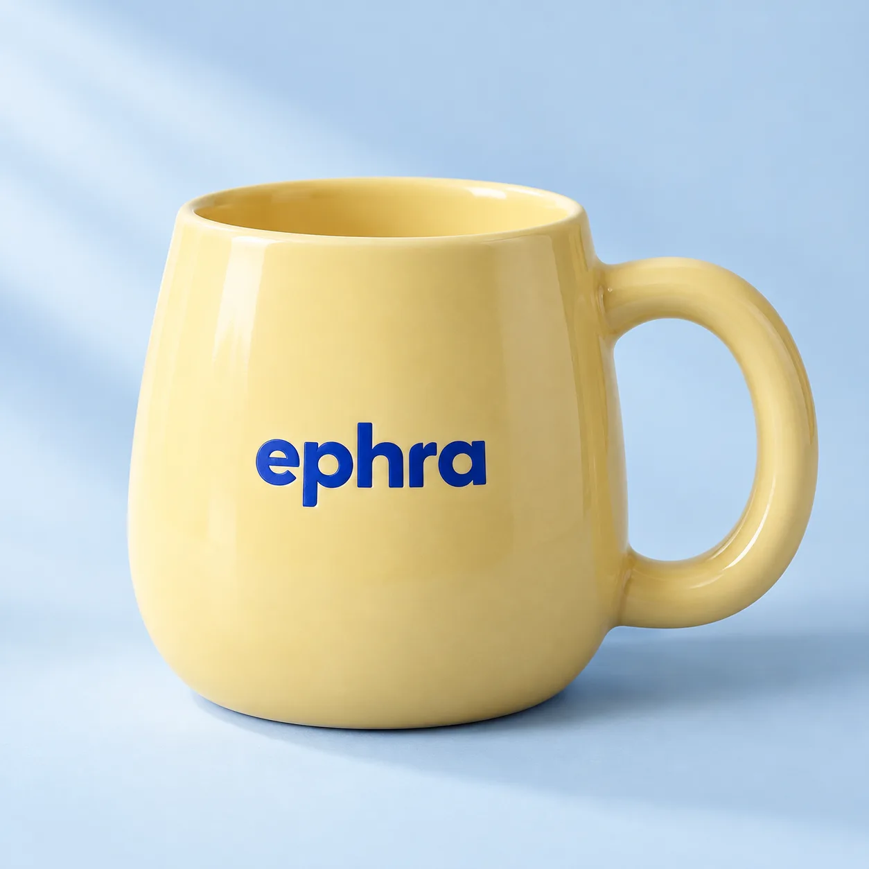 Butter yellow ceramic Ephra mug with a rounded handle. Product concept.